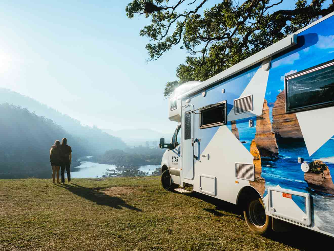 Couple enjoying view by Star RV motorhome