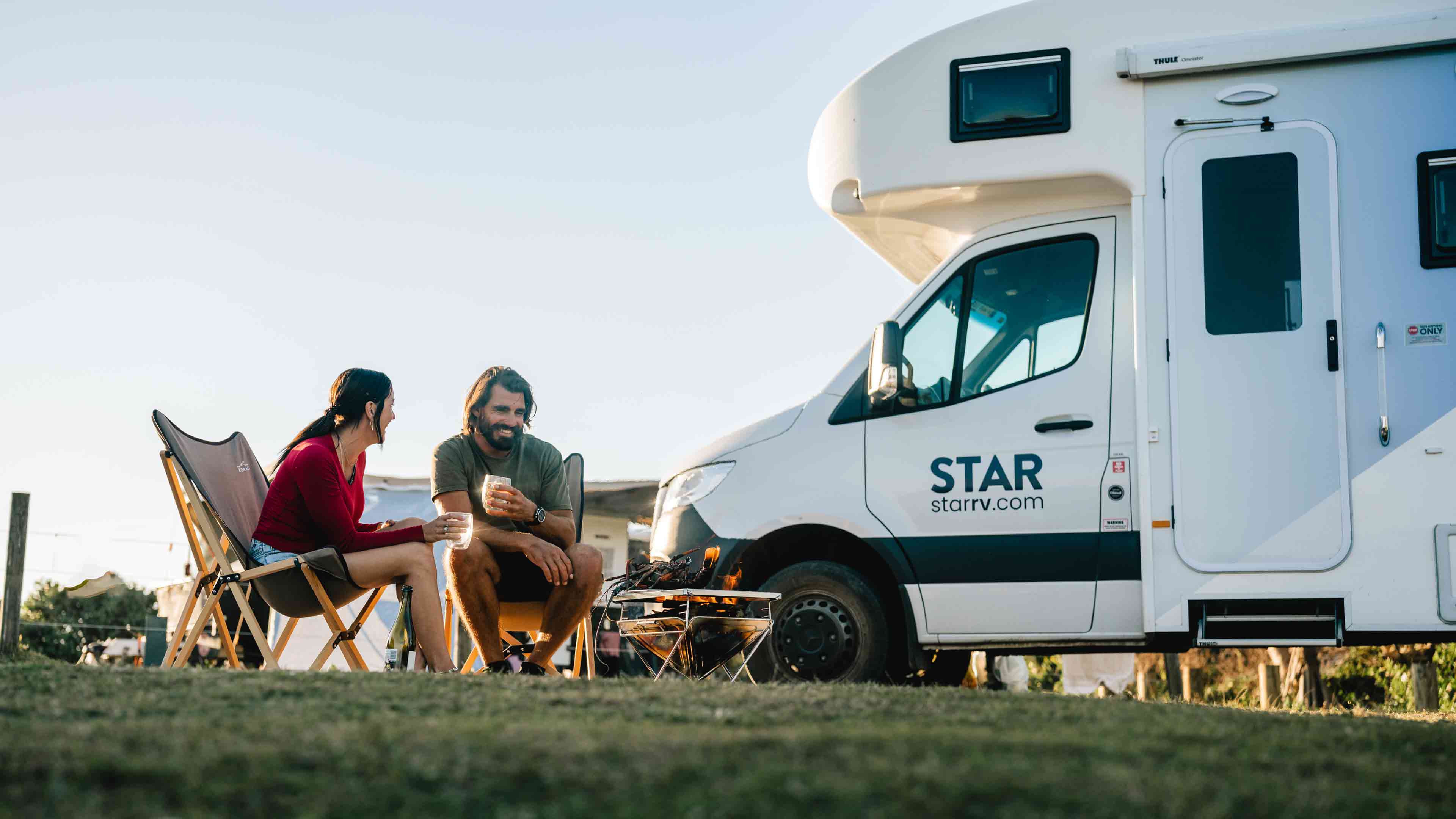 Couple sitting outside motorhome